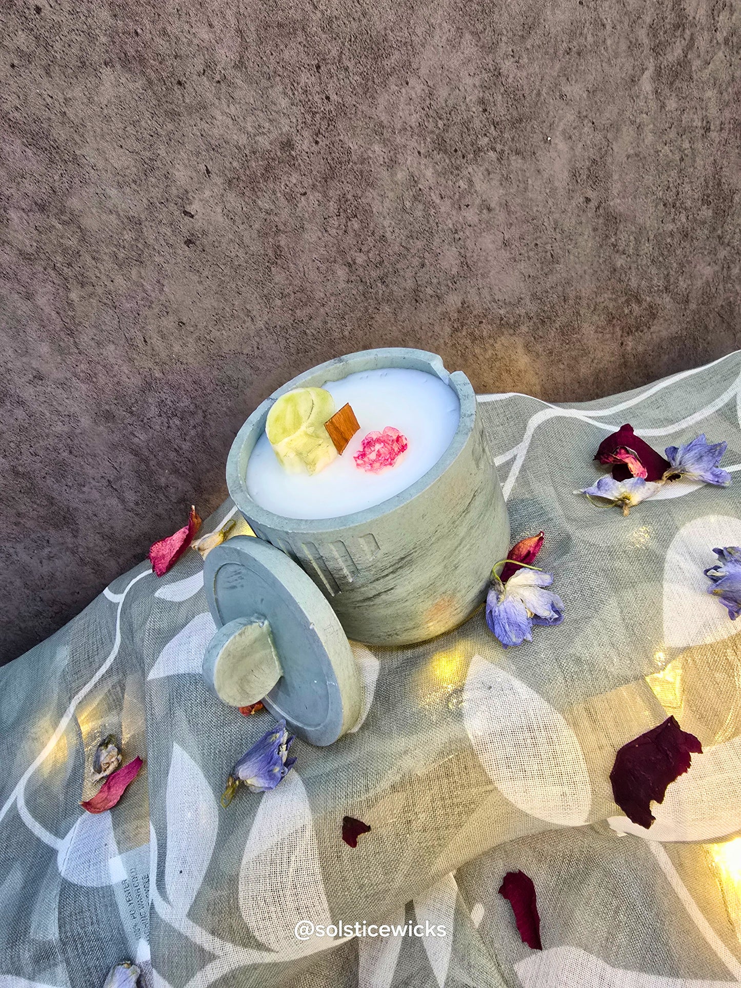 Solar Kiss Candle in concrete jar – with bergamot, lavender, rosemary, and patchouli, made from coconut apricot wax.